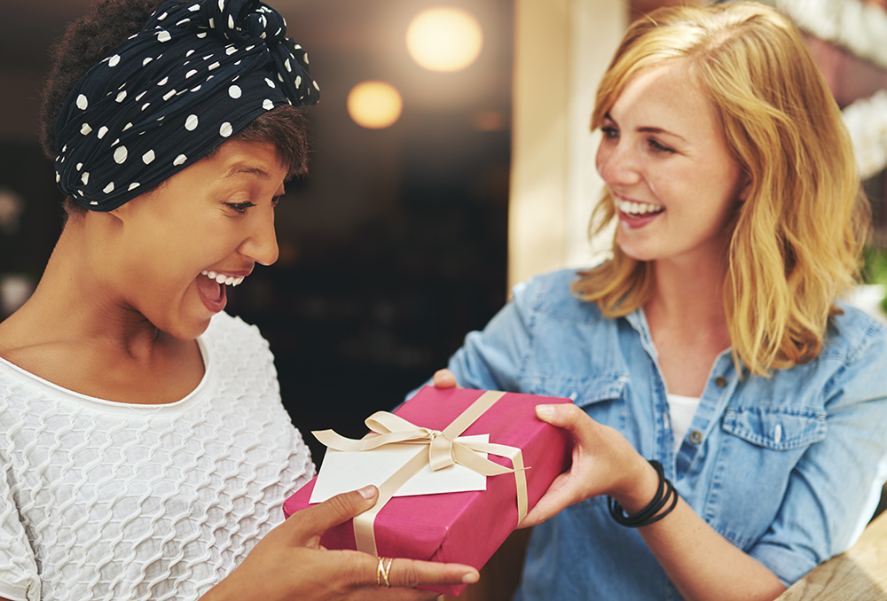 Woman giving friend Mother's Day gift