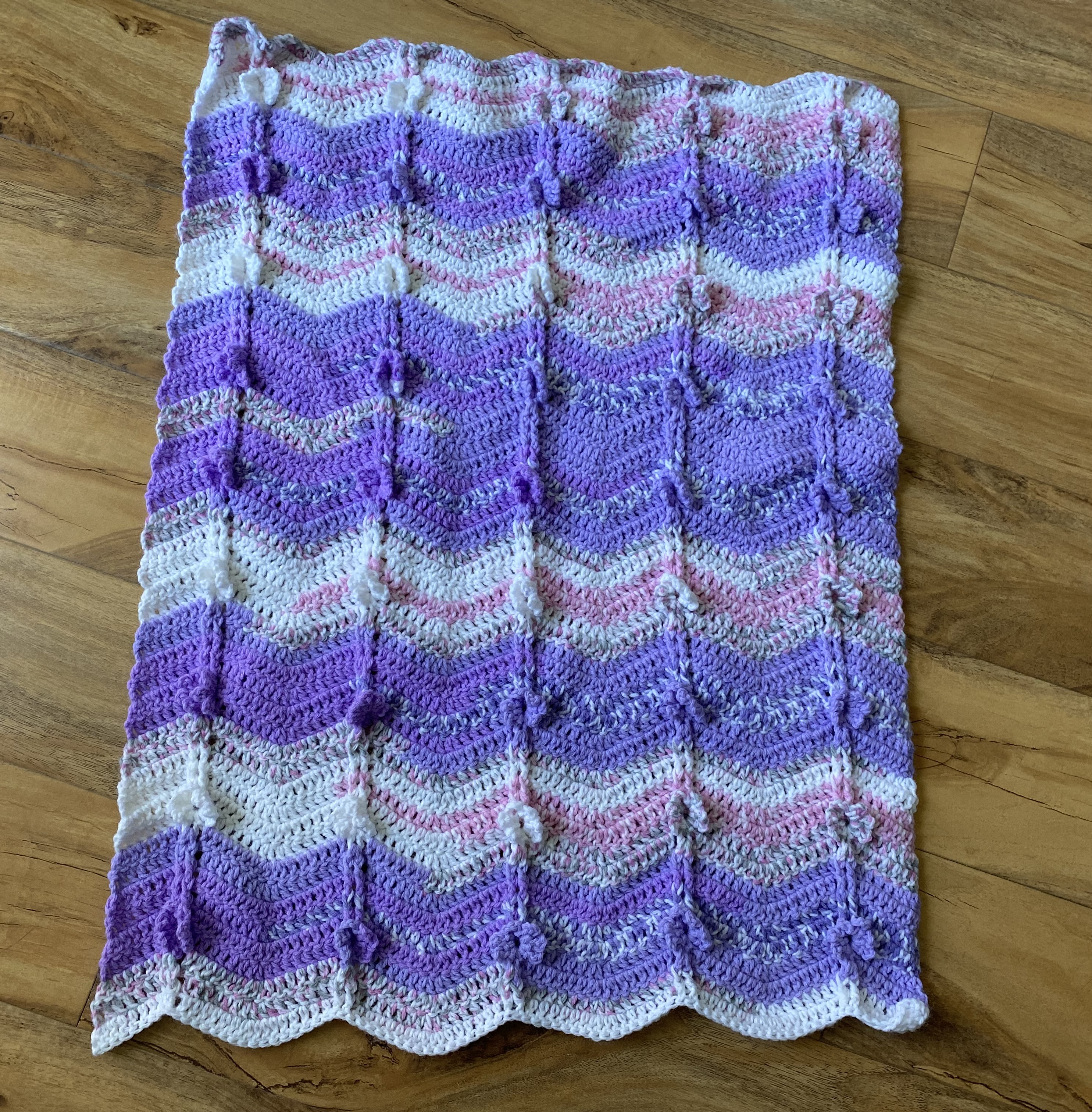 purple and white baby blanket with flowers