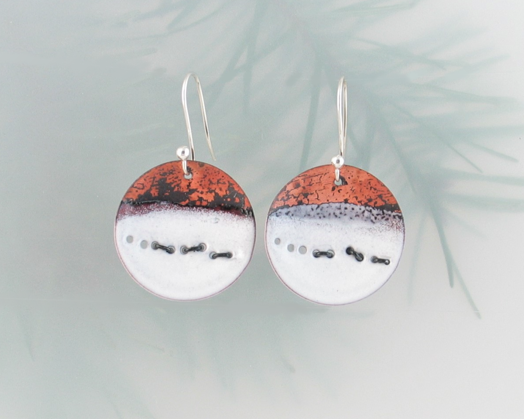 running wolves in snow abstract copper enamel earrings with blackened sterling wire representing running wolves