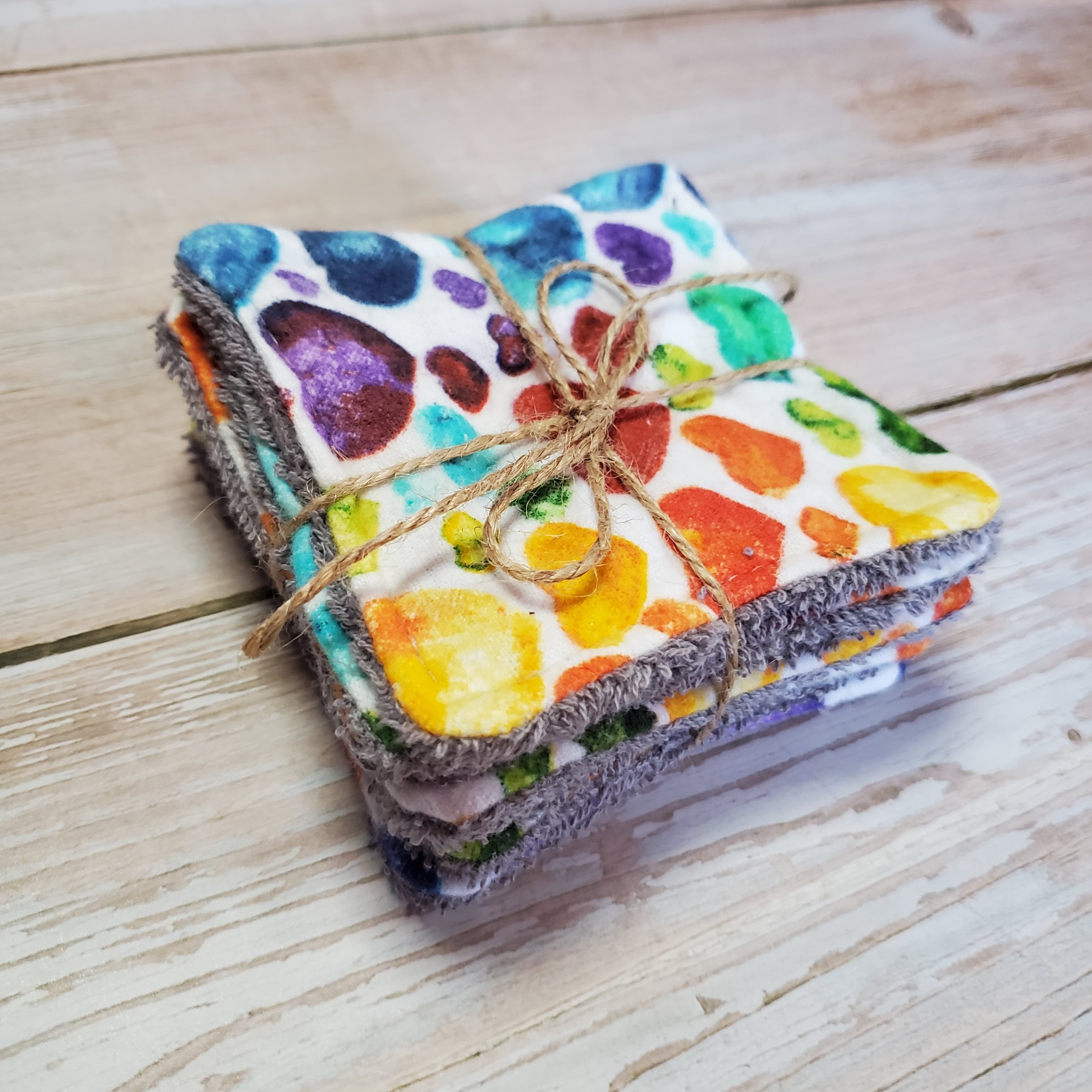 side view of a colorful hears patterned reusable facial square.
