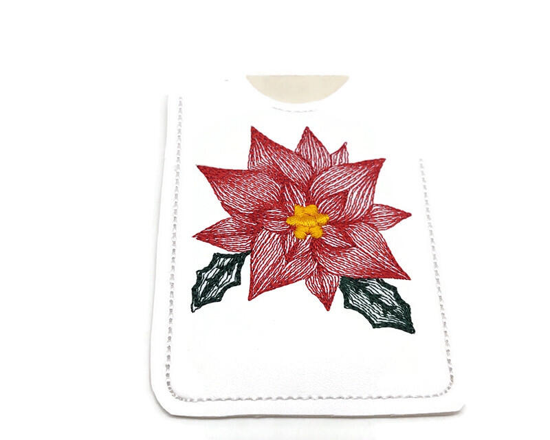 This red poinsettia gift card holder can deliver your card gift to that special person and put a smile on their face.

    What you get:  One vinyl gift card holder with a red poinsettia machine embroidered on it.

    Fabrics Used:   Vinyl, polyester embroidery thread and tear away stabilizer.
    Fabric color:  The vinyl is a white, poinsettia is done in a red with a bright gold center and green leaves with machine embroidery thread.  The outline is done in white.  Each one is hand cut.
    Size:  3 1/4 x 4 1/4 inches.  Picture 3 shows size compared to my hand.
    Care:  Wipe with a damp cloth.