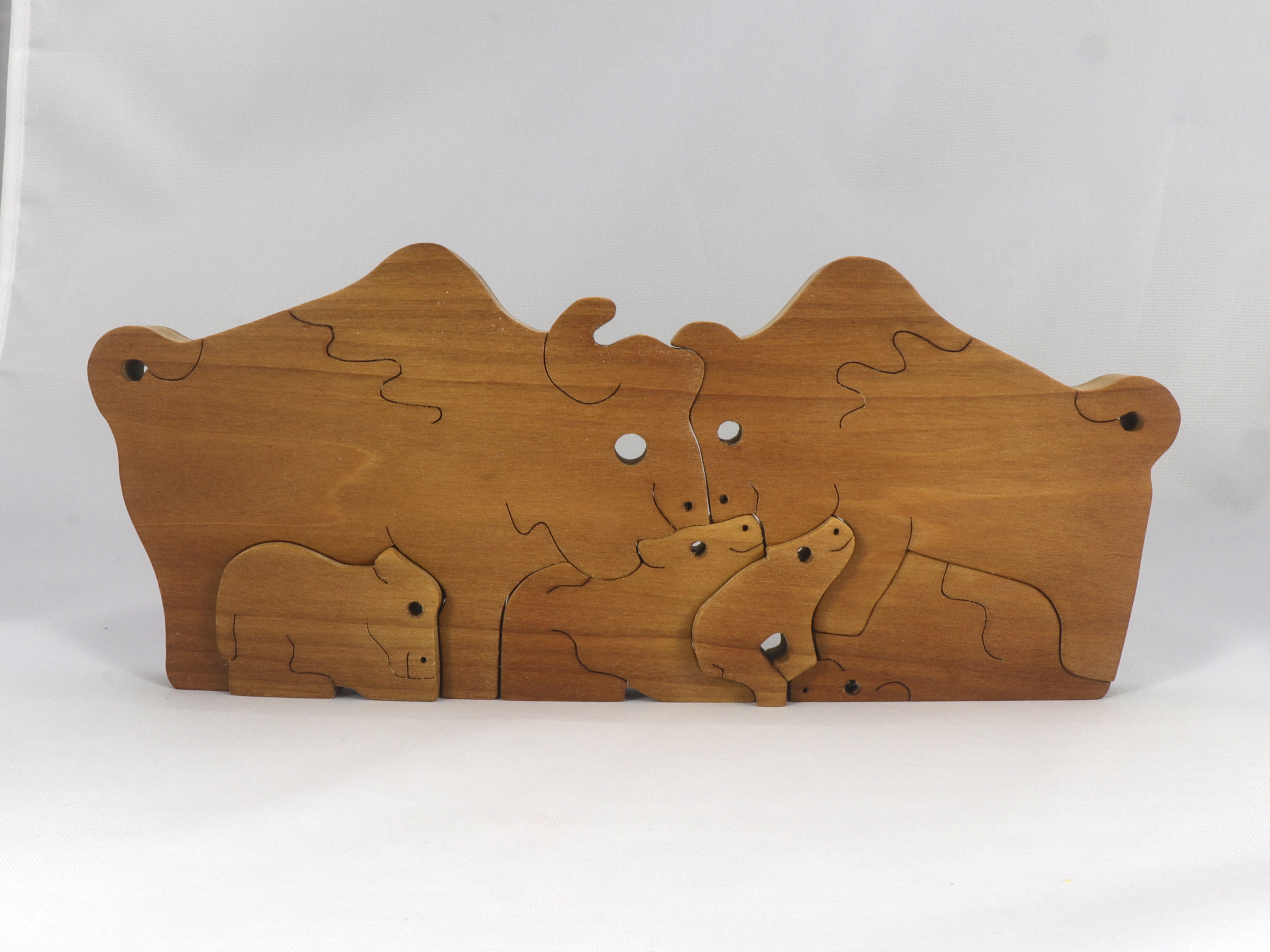 Handmade freestanding buffalo family stacking puzzle made of select-grade hardwoods. Finished with a blend of mineral oil, beeswax, and carnauba wax.