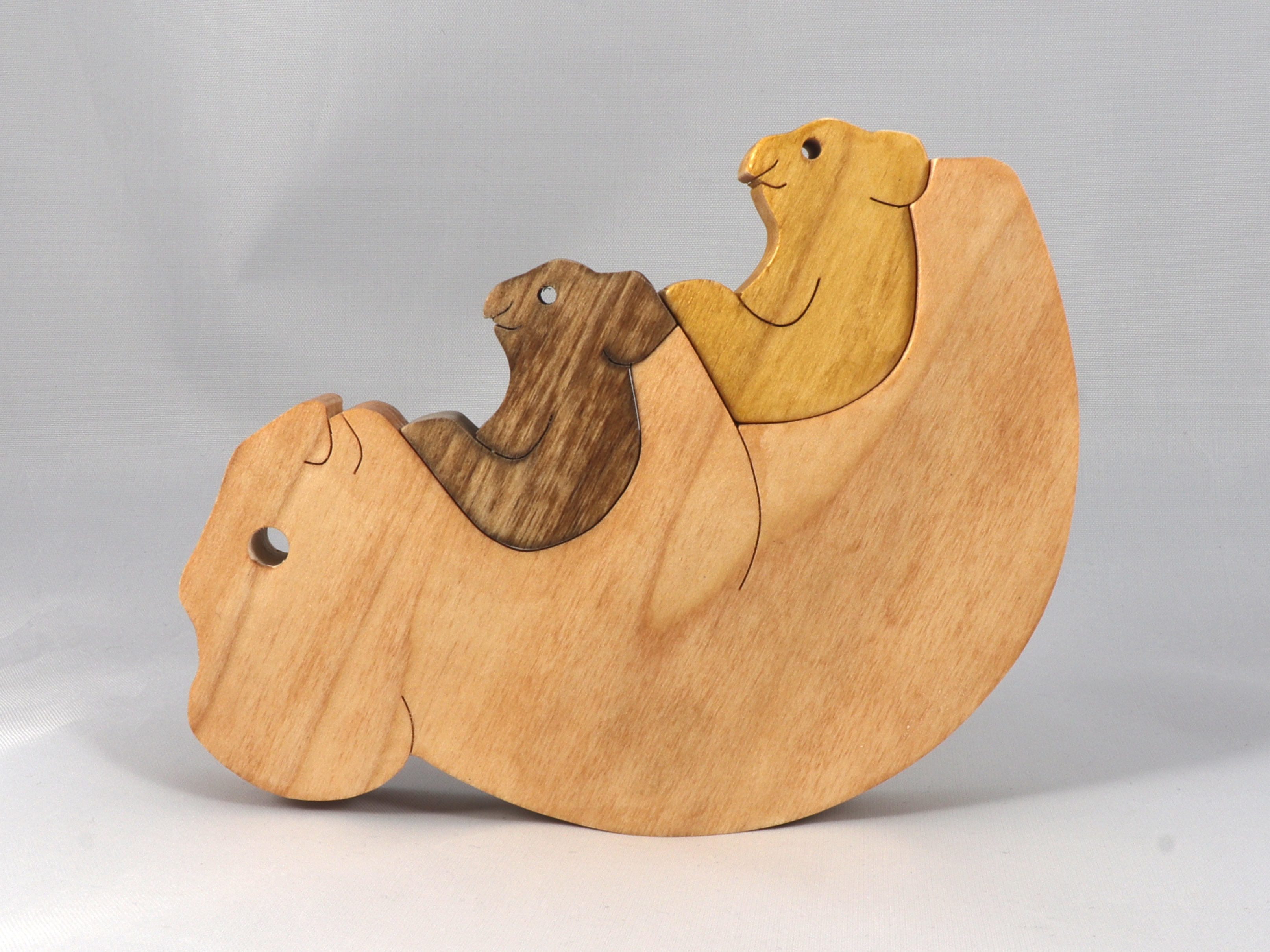 Handmade wooden puzzle featuring a family of koalas, including a mom and two joeys, that can be stacked or displayed freestanding as a toy animal.