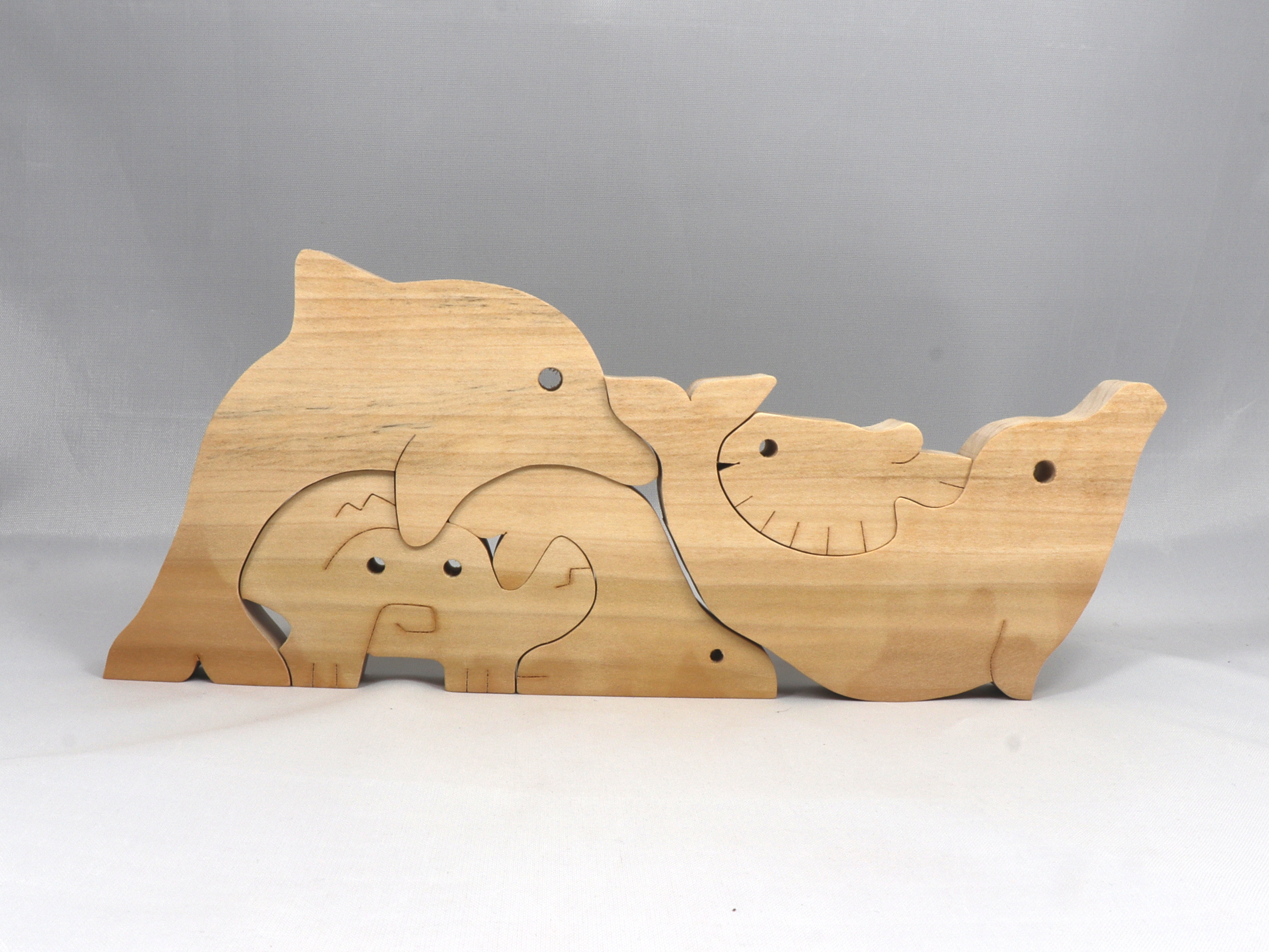Wood Sea Life Family Stacking Puzzle Handmade From Premium Grade Hardwood and Hand Finished With Clear Shellac. Animals Include a Dolphin, Crab, Seal, and Fish.