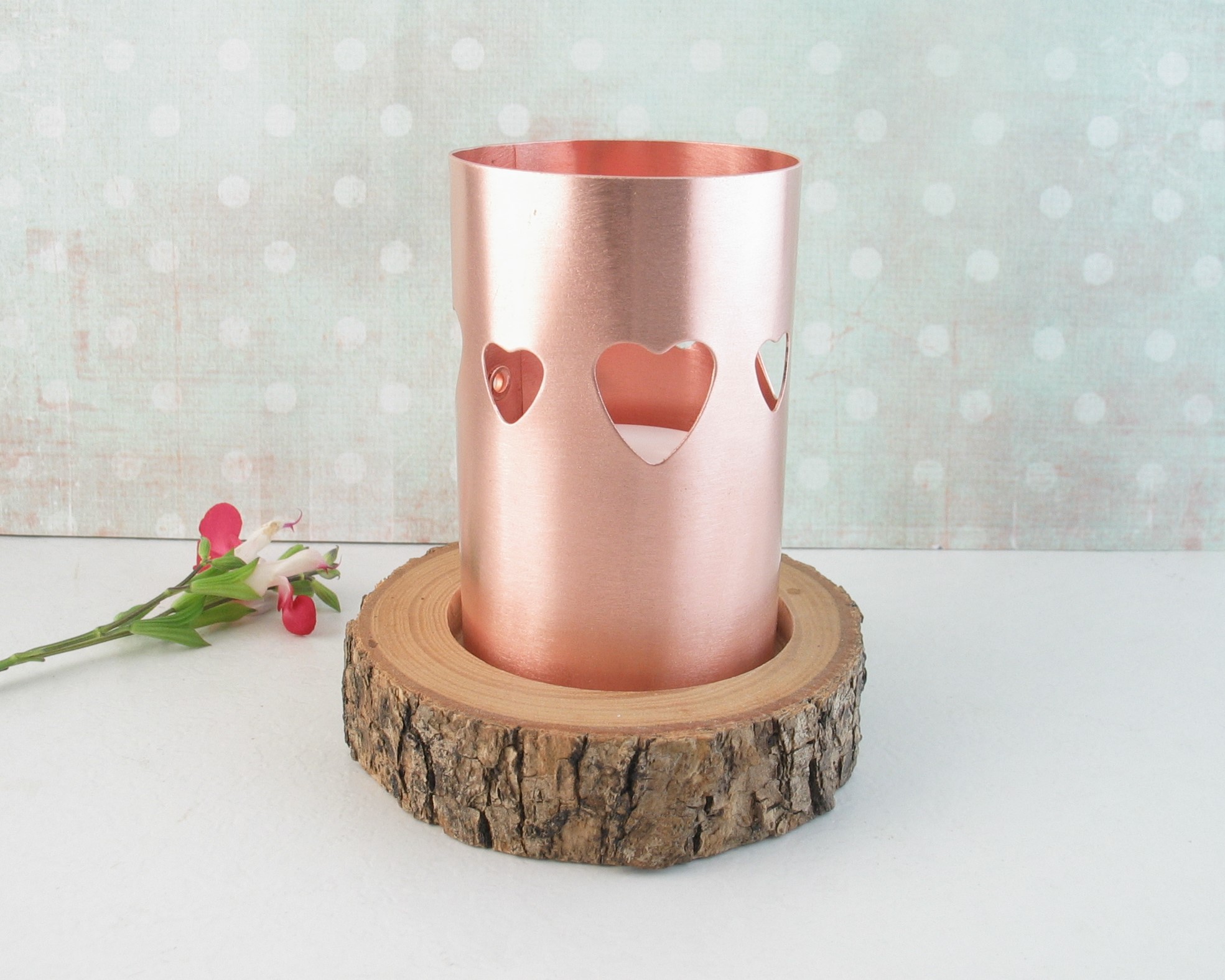 Scandanavian style heart-pierced copper chimney tea light candle holder on live-edge wooden base cut from tree limb. comes with flameless tealight candle.