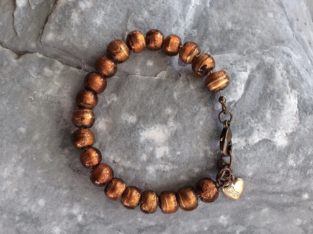 Rustic amber glass beaded bracelet with vintage brass heart charm