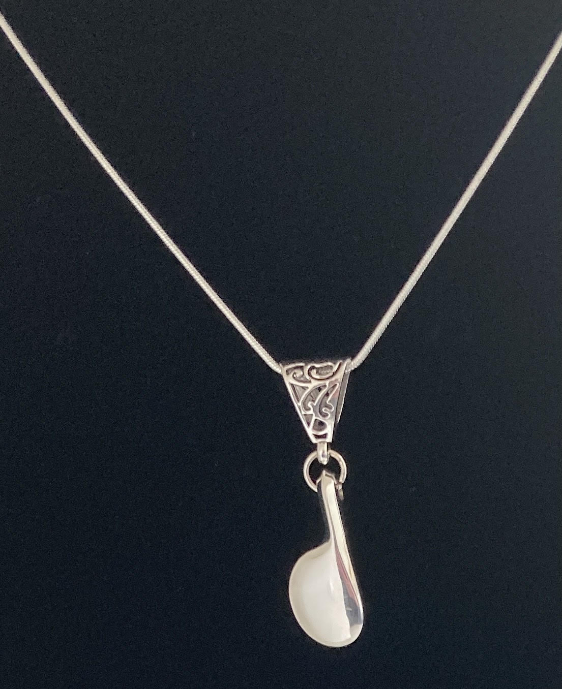A  unisex necklaces with an Eb SILVER flute key. Bold and making a statement with a patina bail and silver plated necklace.  Though we do not engrave this gorgeous amount of SILVER handles a bold initial engraving which may be done.