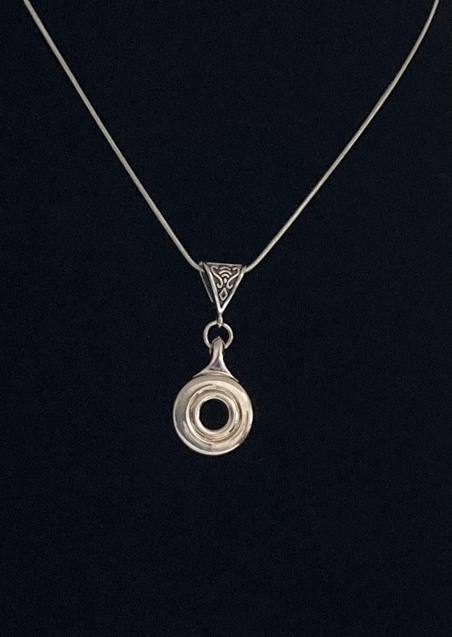 French model open hole flute key crafted in silver and suspended on an antique bail and snake chain. Gorgeous jewelry for the flutist.