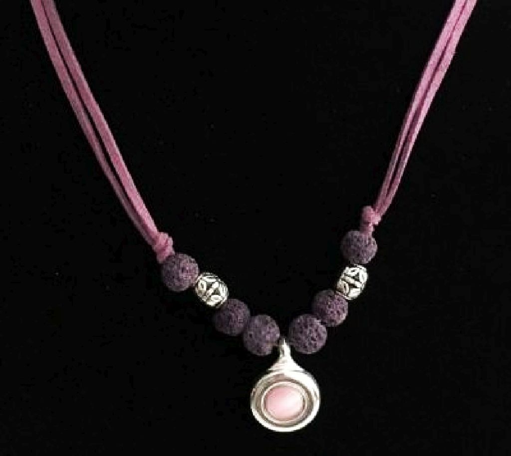 Hues of purple is the main design of this necklace.  Dark purple lava beads, antique silver tone patina barrel beads, silver plateau flute key pendant with a pinkish purple cateye crystal. We finished this item with lighter purple suede cord and heart clasp.Stunning necklace for a flutist or anyone as is it not musicians definitive.