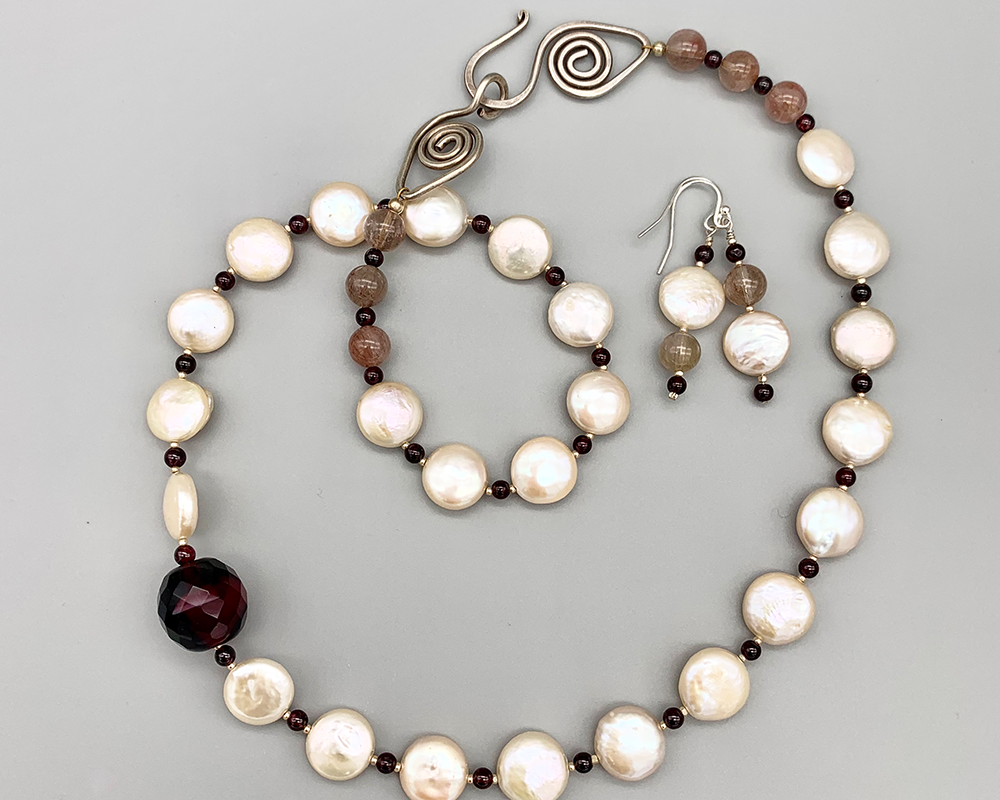 Freshwater pearl coins, wine red mid-century focal bead, garnets, quartz, artisan-forged sterling clasp