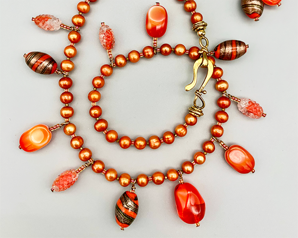 Charm necklace set | Vintage glass beads dangling from a strand of orange freshwater pearls
