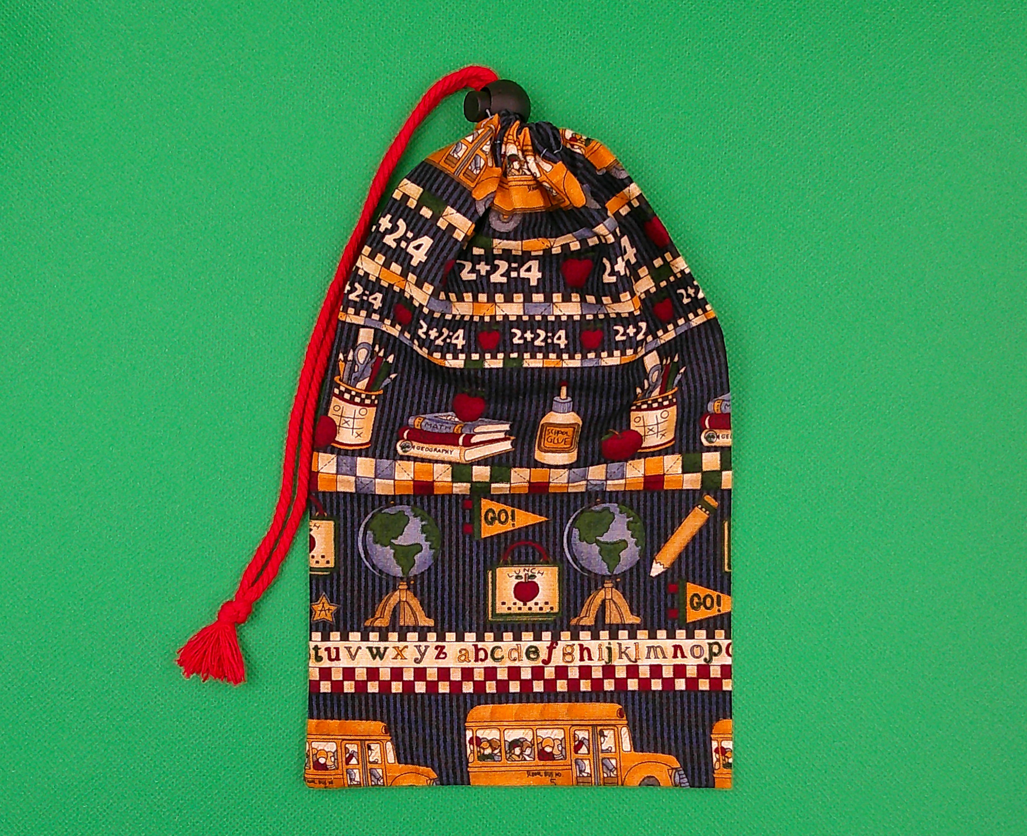 This fun game bag is closed with a nice red cord and toggle. This fun game bag is closed with a nice red cord and toggle.