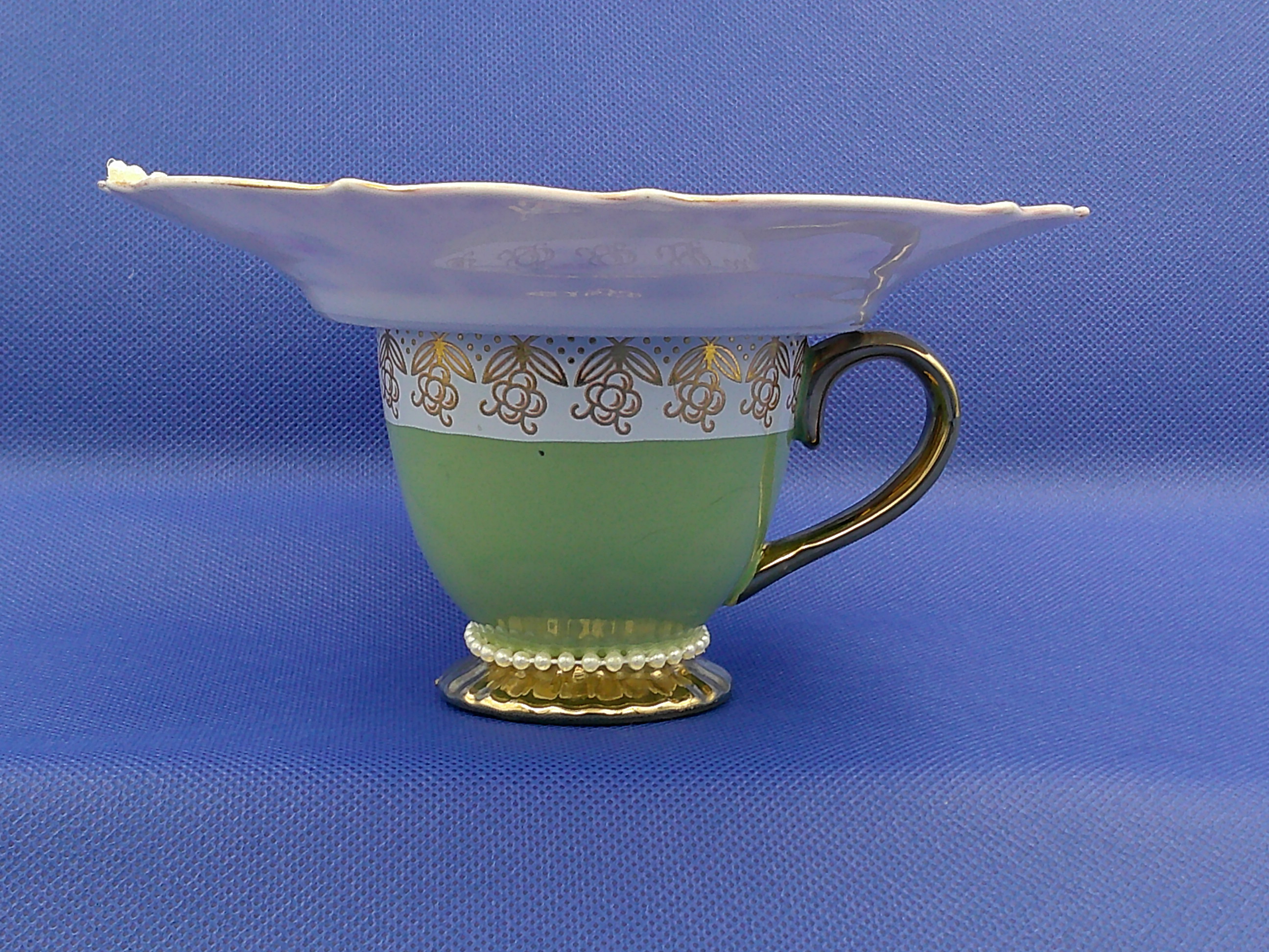 Looking straight at it, you can see the pearls around the base of the cup and the pearl flower peeking over the saucer.  Looking straight at it, you can see the pearls around the base of the cup and the pearl flower peeking over the saucer.