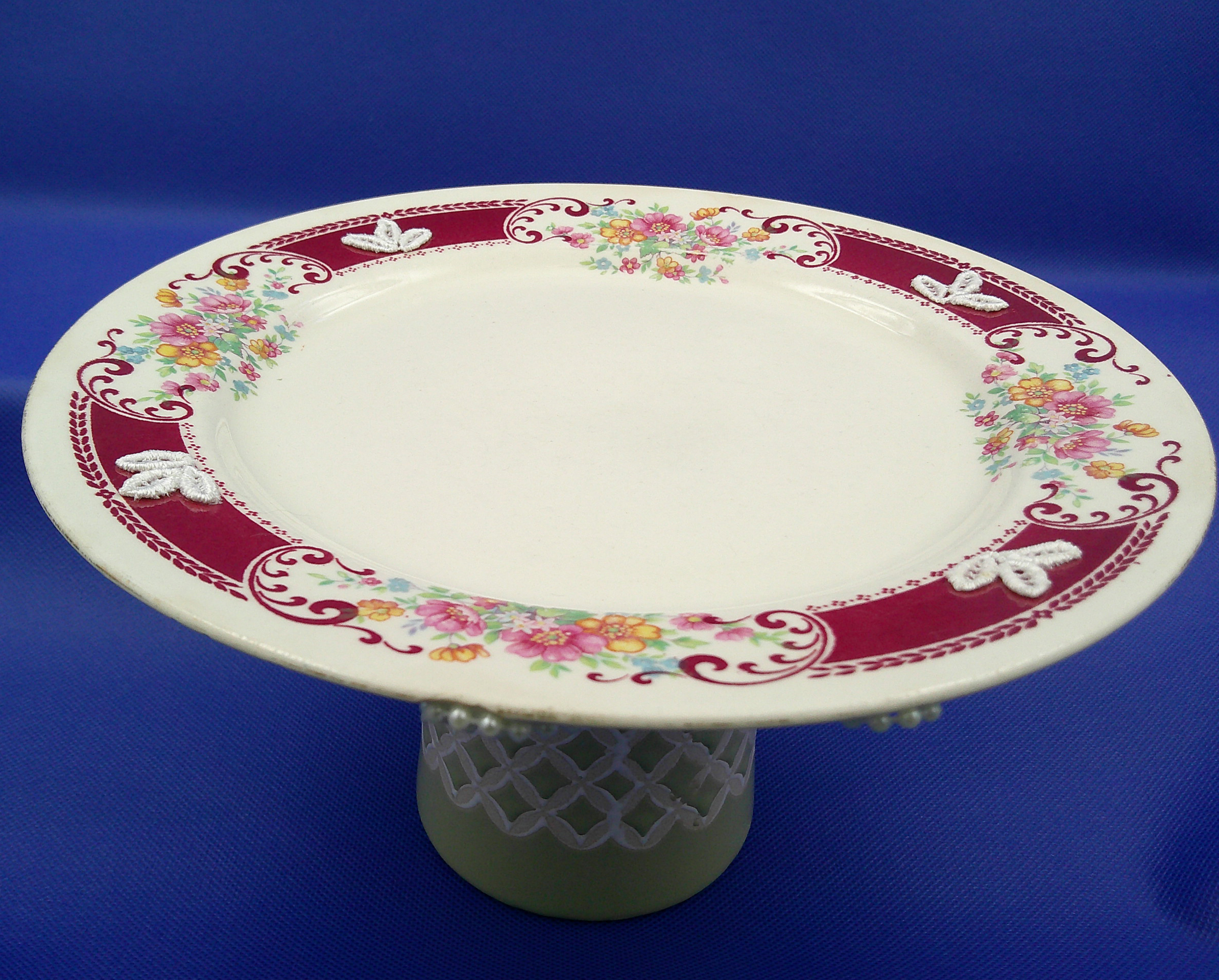 This decorative dish stand is ready to be used to serve goodies or hold your jewelry. It's 9 inches wide by 5 inches high. This decorative dish stand is ready to be used to serve goodies or hold your jewelry. It's 9 inches wide by 5 inches high.