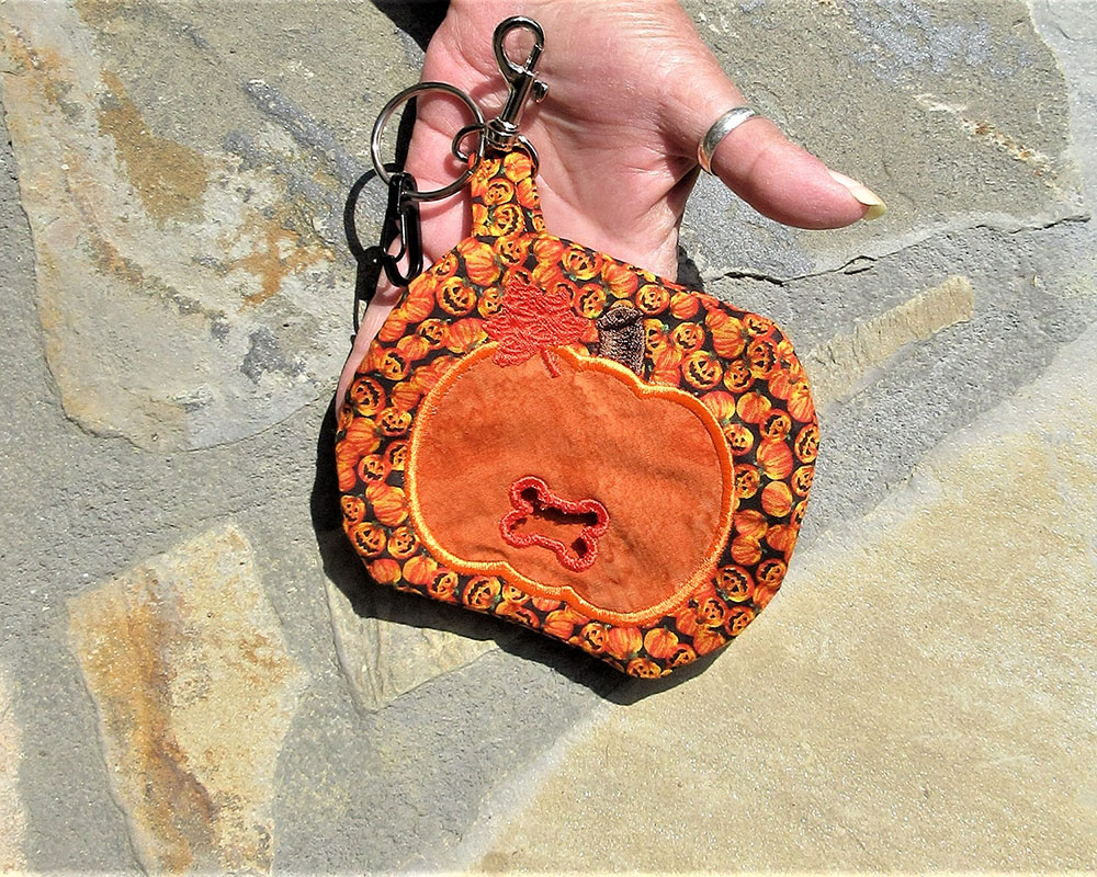 pumpkin shape dog poop bag holder big enough for keys cards masks when you go walking your dog .  Hand crafted in the USA by A Fur Baby Favorite