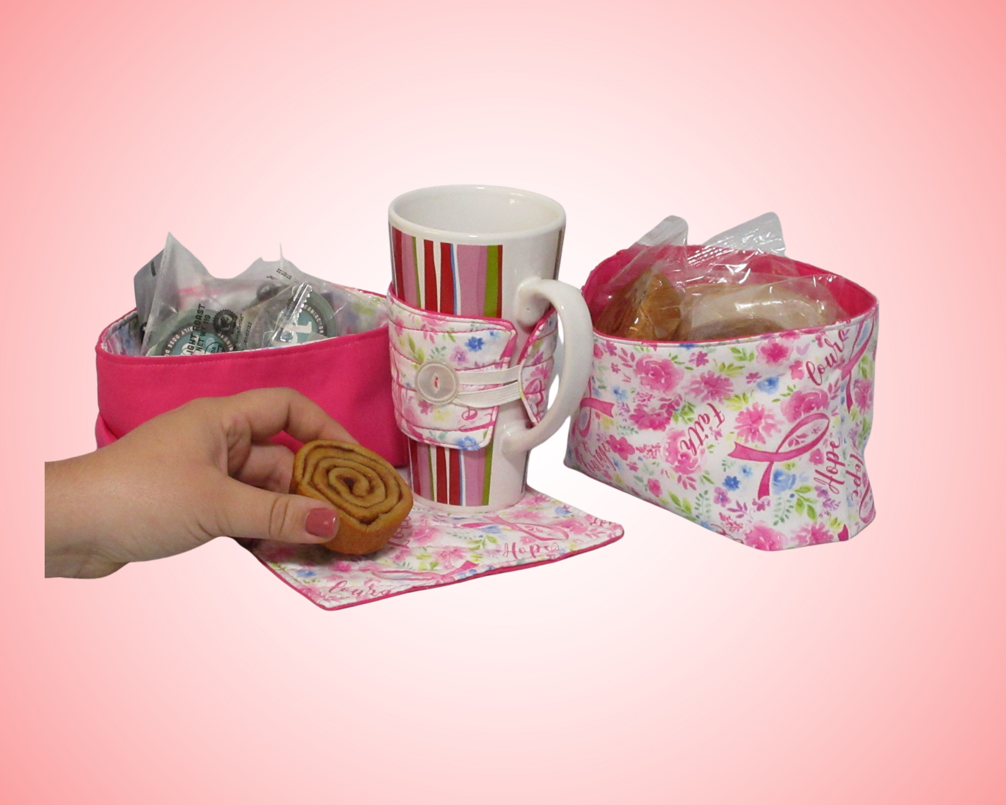 Pink ribbon caring gift set - 2 fabric baskets, one large mug rug / coaster and a cup cozy in pink ribbon, flowers, and words of hope pattern with a hot pink reverse.  In addition all products are reversible and support Breast cancer research.