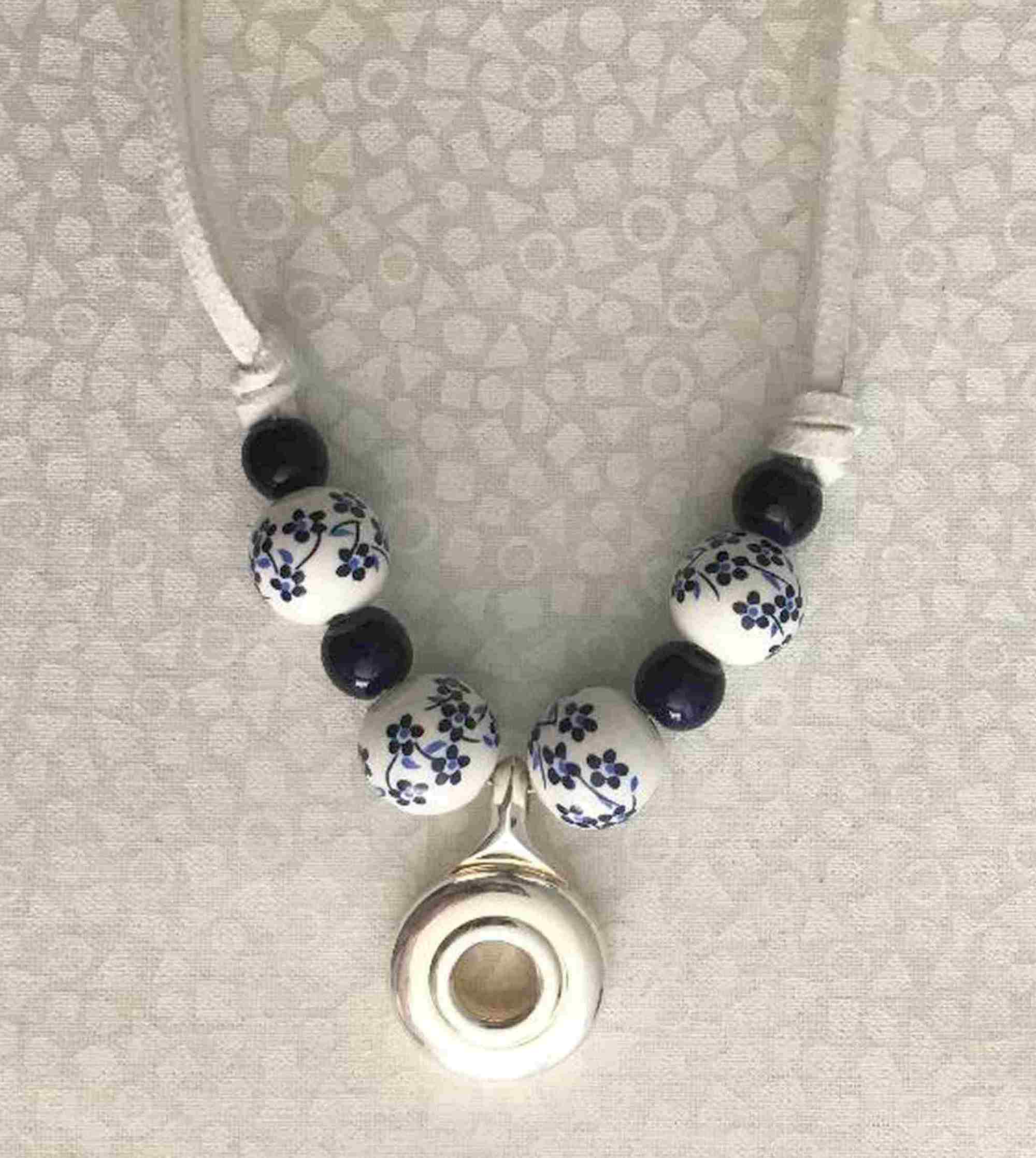 closeup of beads and flute key pendant.