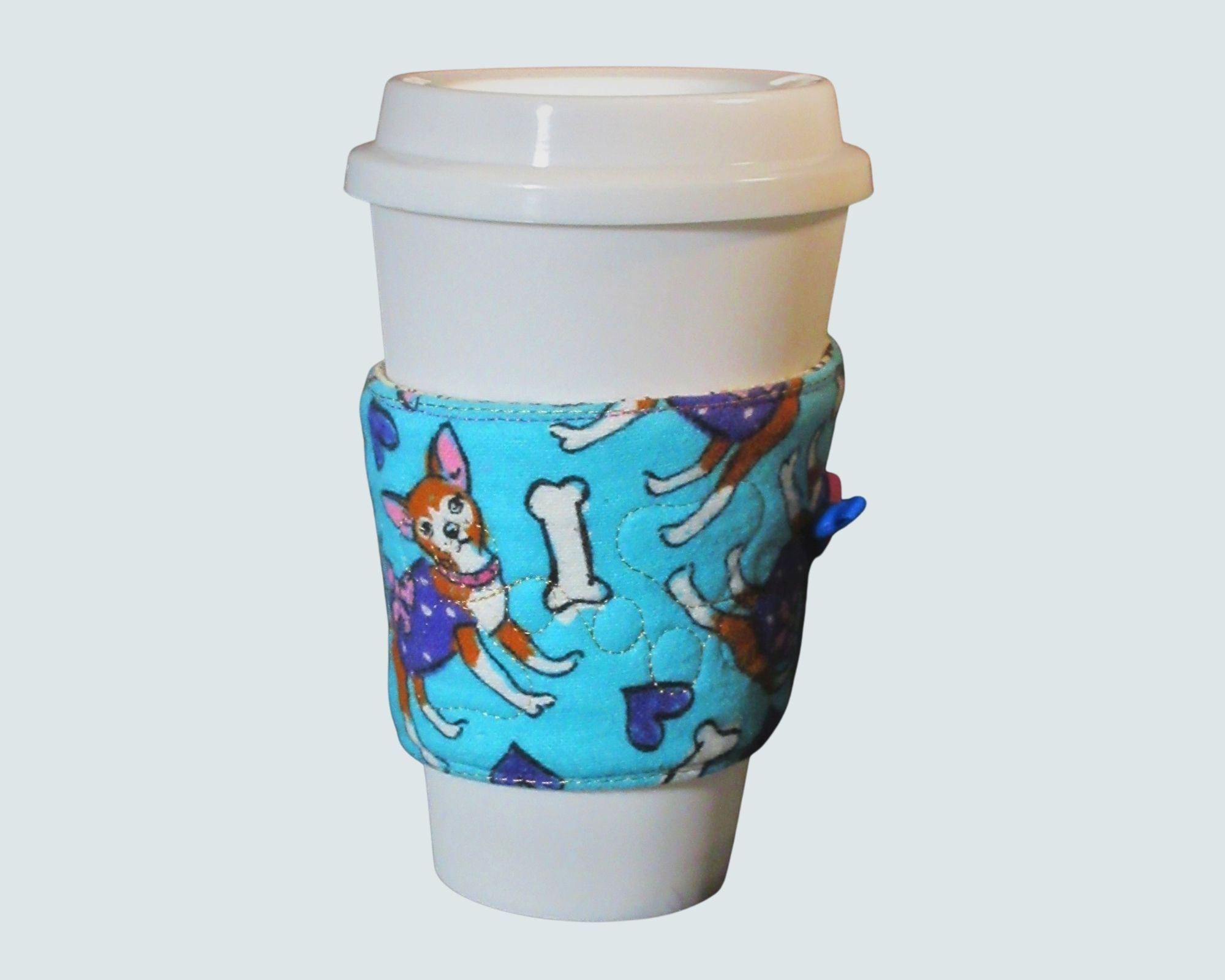 Chihuahua Coffee beverage sleeve.

This cozy fits most to go cups and is made of cotton. Chihuahua with hearts and bones and embroidered / quilted flannel top, and fully lined with a great coffee / tea print on the inside.

This will keep your hands cool and give you a warm heart. 25% of the proceeds go to the Georgia English Bull dog Rescue.